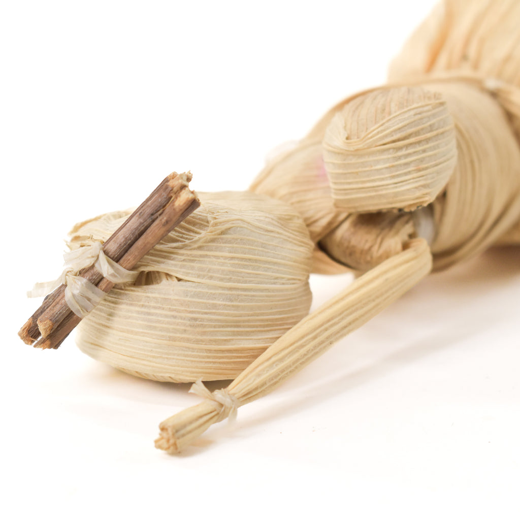 detail of wood carried by Mother and child made of corn husk.