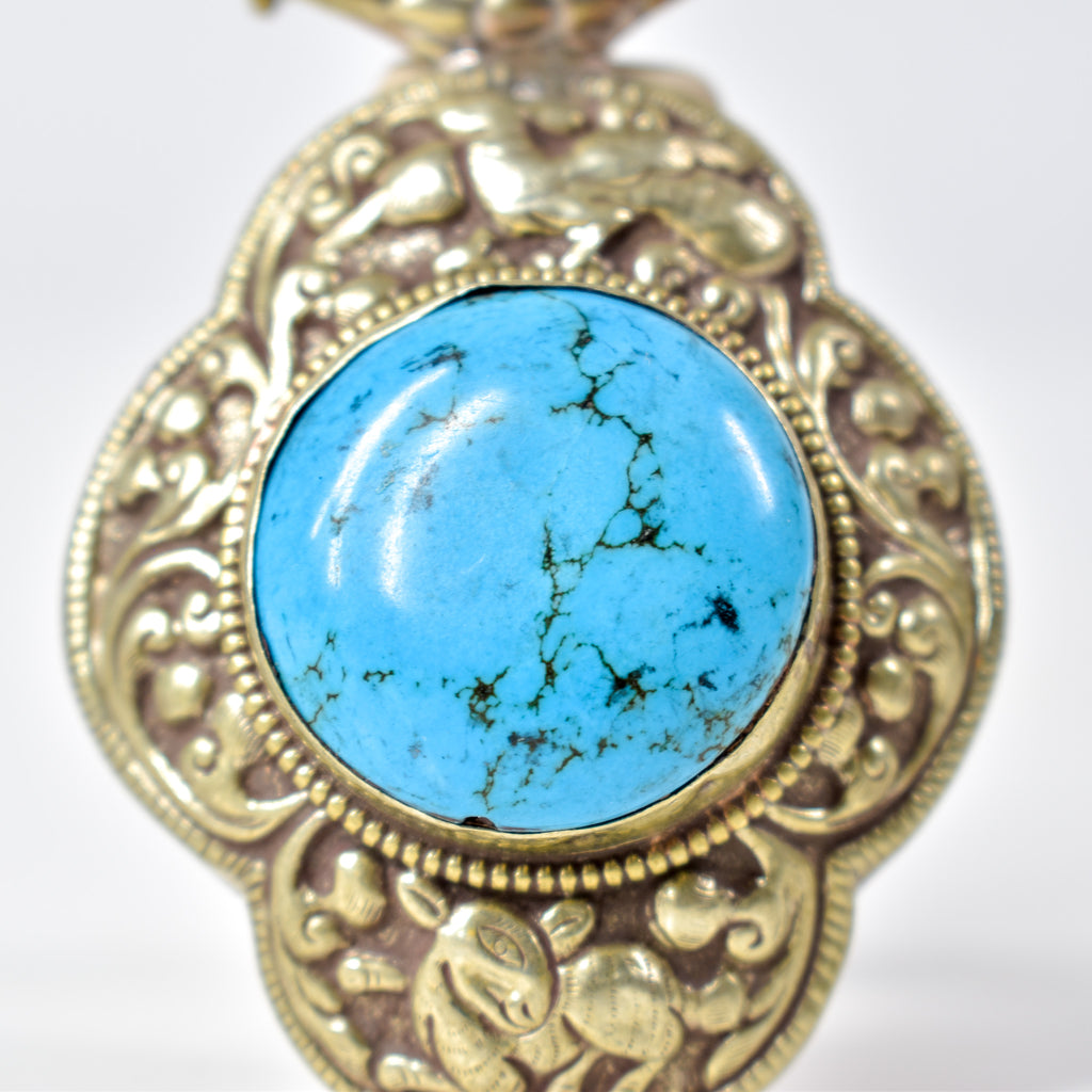 Tibetan Turquoise Colored Repoussé Pendant