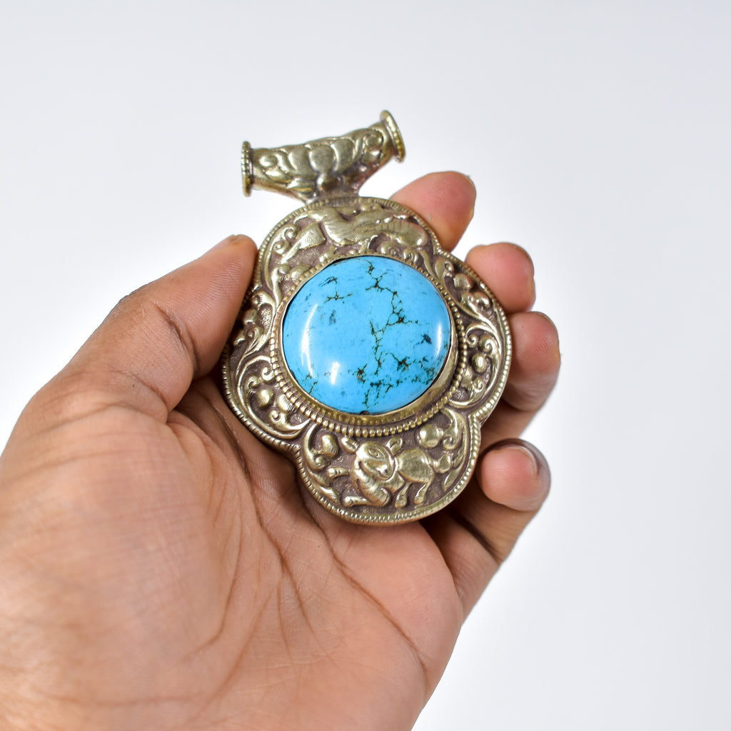 Tibetan Turquoise Colored Repoussé Pendant